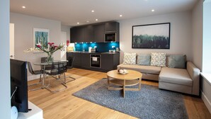 A modern apartment with a kitchen, dining area, and living room. - Hampden Apartments - The Edward (Windsor)