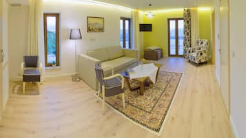 Deluxe Suite, Lake View | Living area | TV
