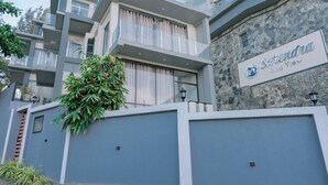 A modern multi-story building with a sign indicating 'Sarenhotu Sea View.' - Surendra Seaview (Matara)