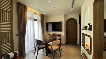 Executive Suite, Balcony, Garden View | Living area | 65-inch Smart TV with digital channels