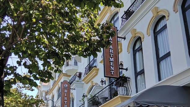 A row of European-style buildings with signs for 'JB Apartment' and 'JB Bistro'. - JB Serviced Apartment Phu Quoc (Phu Quoc)