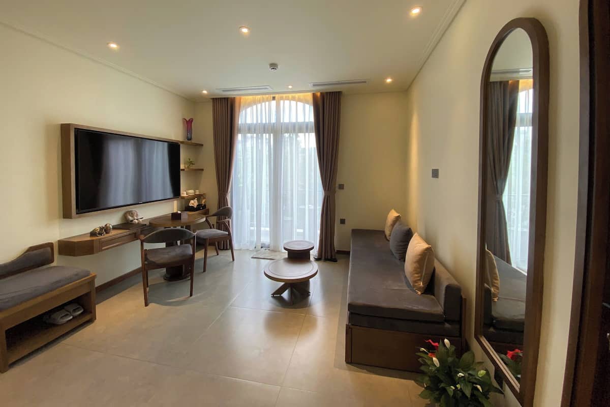 Superior Suite, Balcony, Garden View | Living area | 65-inch Smart TV with digital channels