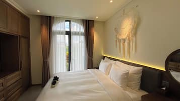Relax in comfort with a large bed, wall-mounted artwork, and a spacious desk area.