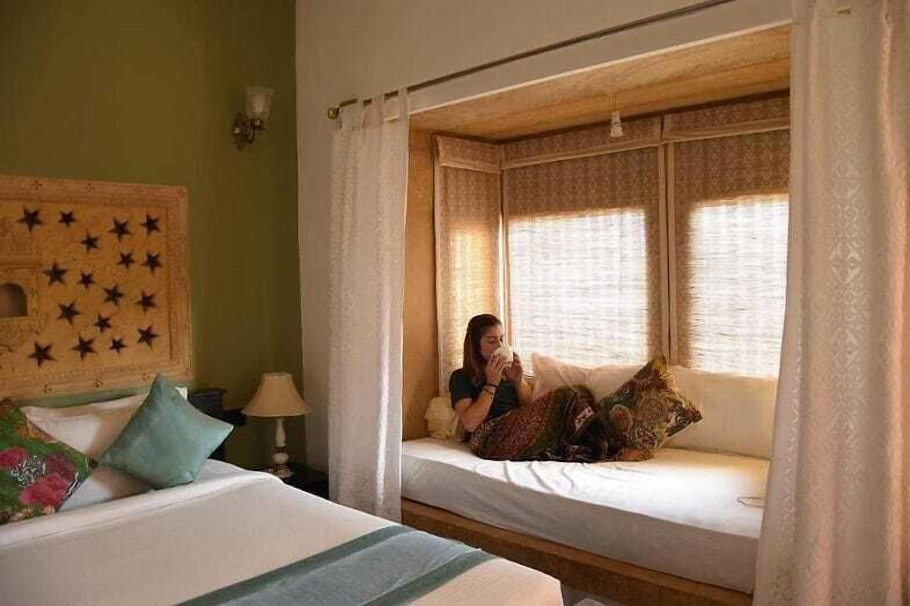 Ein Zimmer mit Bett, Fensterbank und einem Kopfteil mit Sternenmuster.