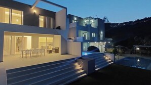 A modern multi-story house with a pool and outdoor seating area. - Luxury Villa (Chania)