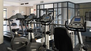 A gym with treadmills, elliptical machines, and exercise bikes. - Knightsbridge Luxury Apartments Century City by Vvip Bookings  (Cape Town)