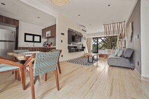 Enjoy a comfortable stay in this apartment with a spacious living area, dining set, and kitchen with modern appliances.