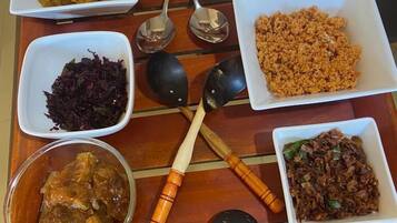A wooden tray with various dishes and utensils.