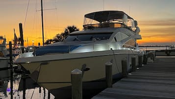 Moored at the marina, this yacht offers a covered upper deck.