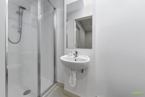 Separate tub and shower, towels, soap, shampoo