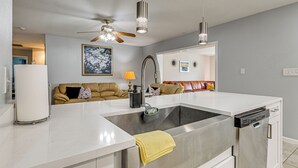 A modern kitchen with a stainless steel sink, a ceiling fan, and pendant lights. - 10 Mi to Adventure Island: Home w/ Fenced Yard! (Lutz)