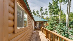 A log cabin with a wooden deck and a covered porch. - Mountain Views: Cabin in Fort Garland Near Hiking (Fort Garland)