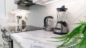 A kitchen with a blender, a kettle, and a plant on the counter. - Choose To Be Happy @ The GAIA [2-Bedroom w/ Pool] (Kingston)