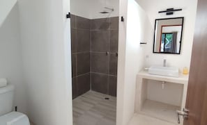 A bathroom with a shower, toilet, sink, and mirror. - 1 Block to Beach, Garden, Air, Kitchenette, C4 (Holbox)