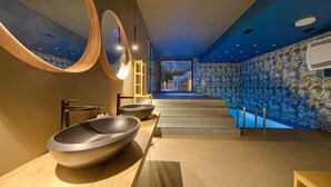 A modern bathroom with two large bowls, a wooden ladder, and a view of a pool through a large window. - Amazing home in Vrh with sauna (Vrh)