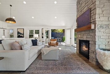 Living room w/ Features French doors which open to the patio overlooking lake 