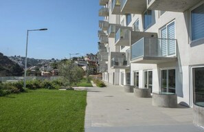 Enjoy expansive views of the surrounding hillside from the building's large windows and balconies.
