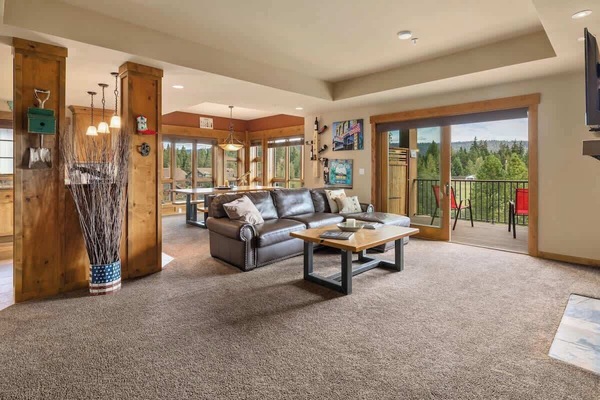 Bright and inviting living area with ample lighting and cozy seating