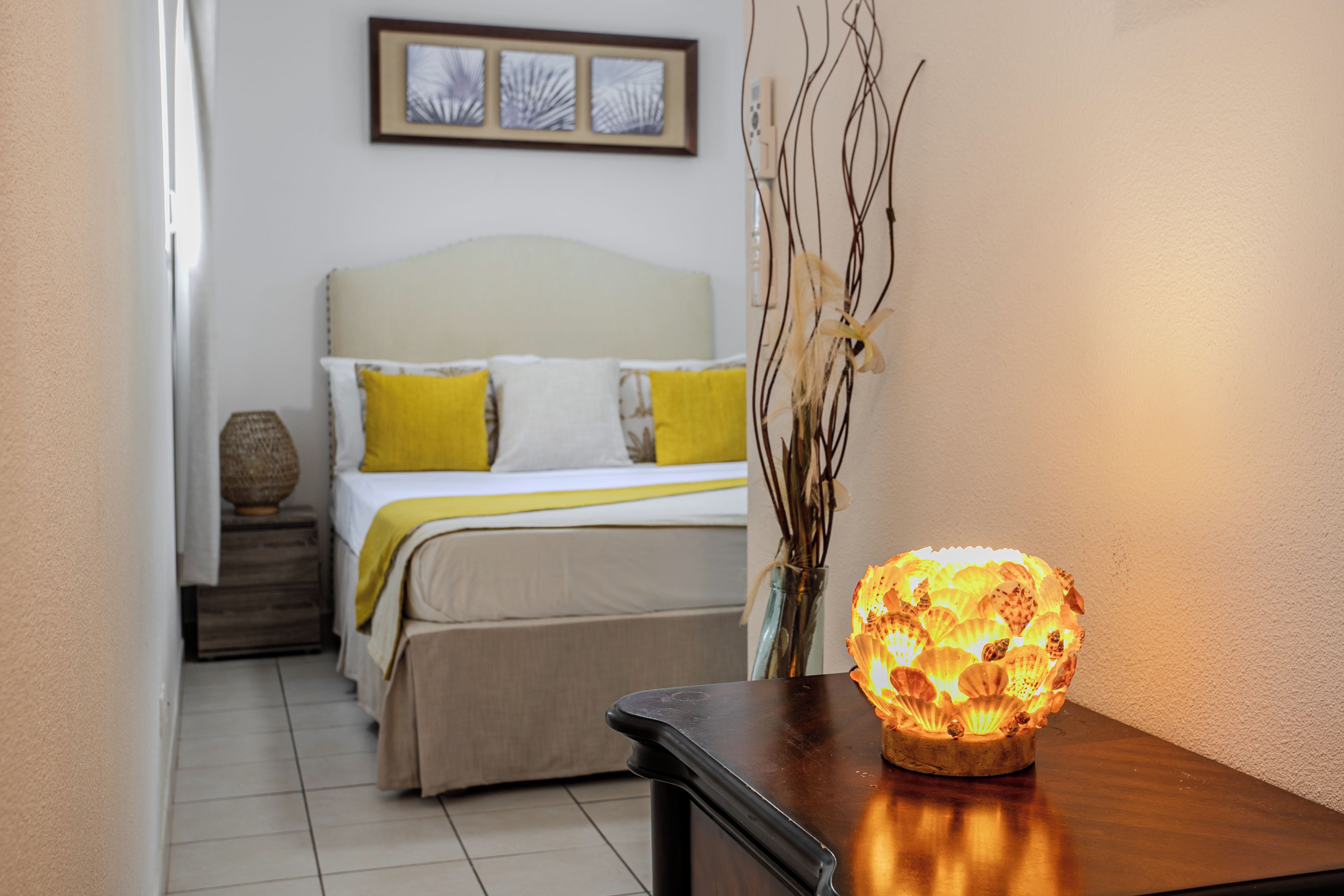 A bedroom with a bed, bedside table, and a decorative light.