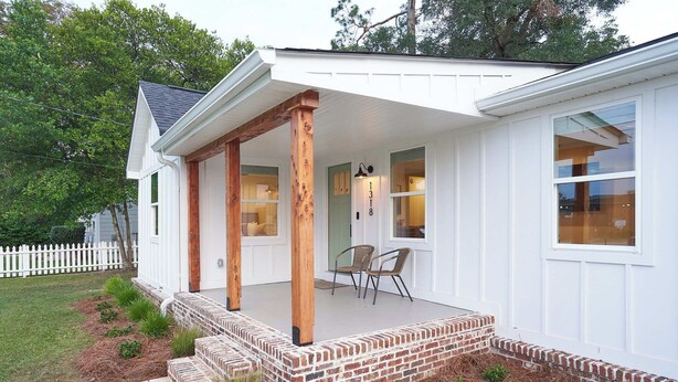 A house with a covered porch, brick steps, and a white exterior. - Historic Cottage in Perry - 3 Bedroom 2 Bath (Perry)