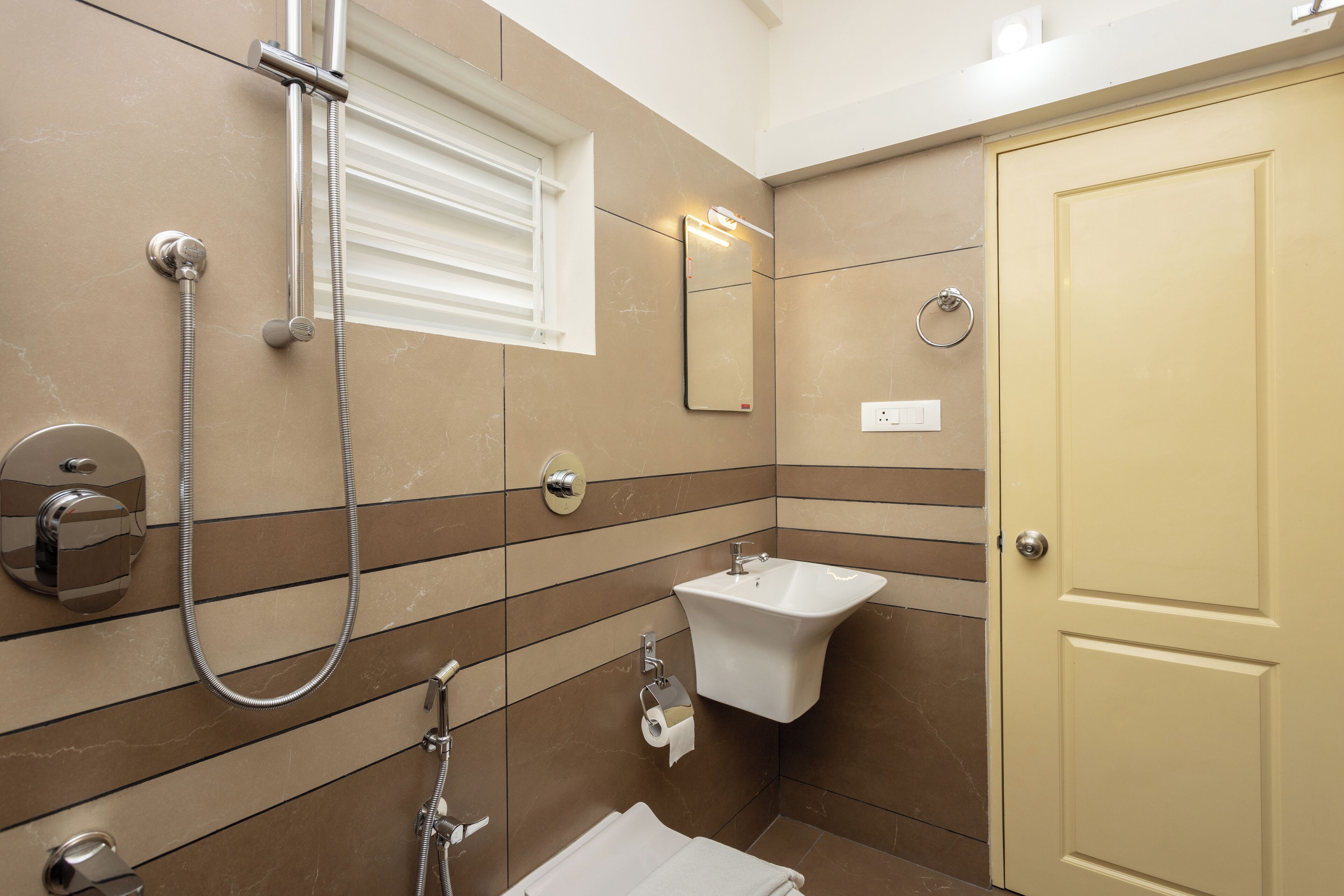 A bathroom with a shower, sink, and toilet.