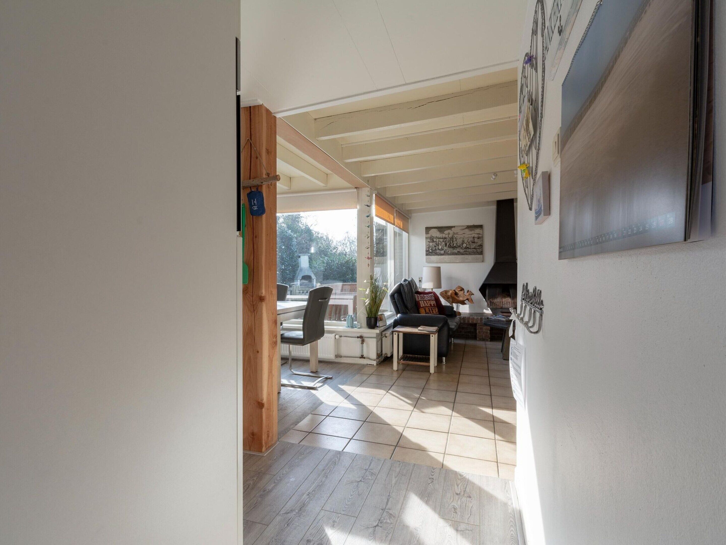 A spacious living area with a fireplace, a dining table, and a comfortable seating arrangement.