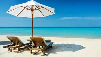 On the beach, sun loungers, beach towels