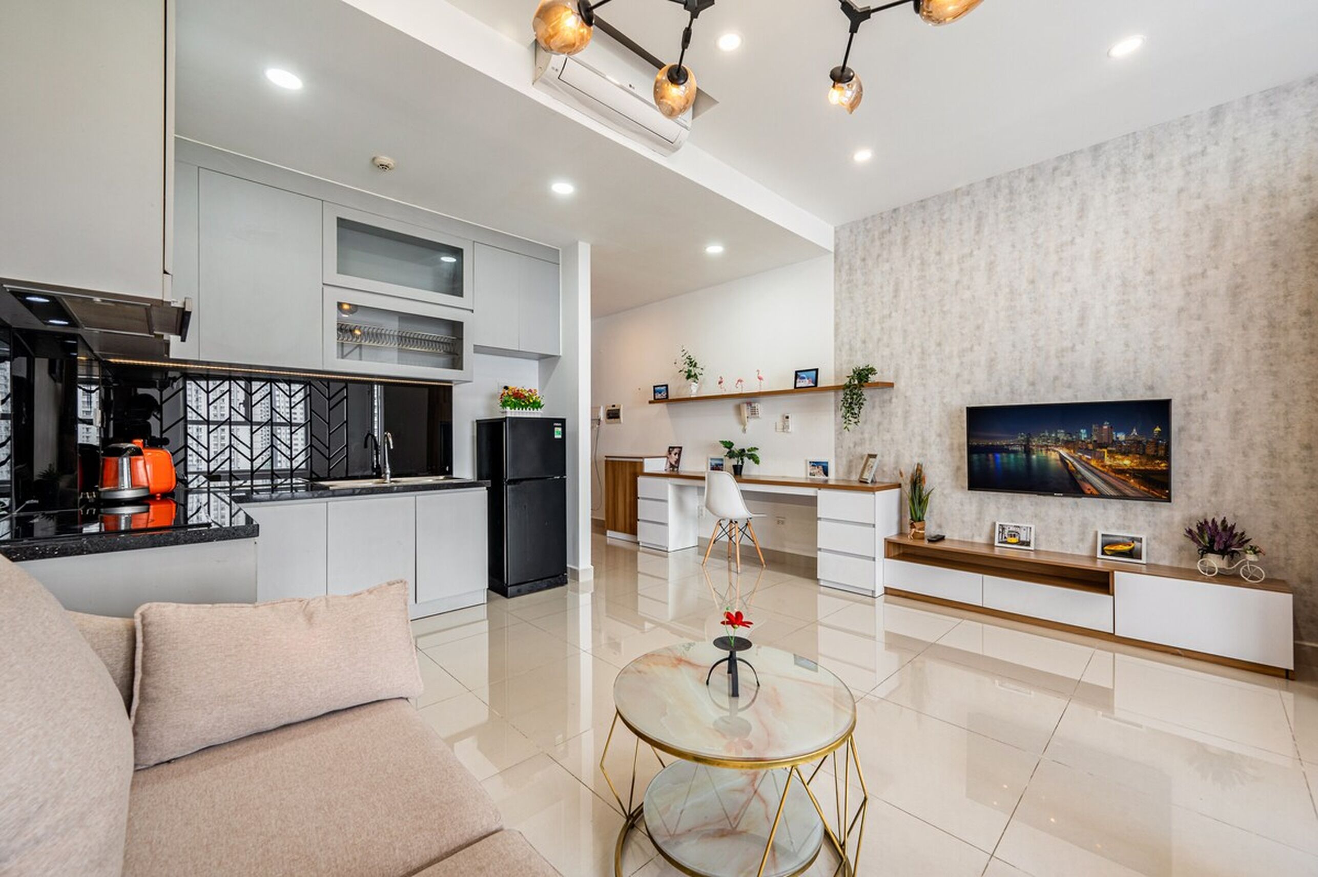 A modern apartment with a kitchen, dining area, and living room.
