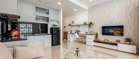 A modern apartment with a kitchen, dining area, and living room.