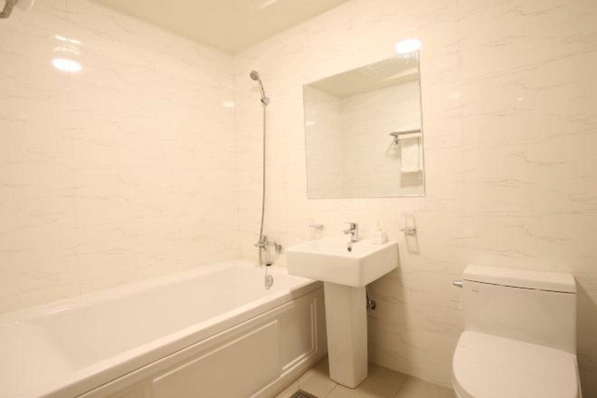 A bathroom with a bathtub, sink, and toilet.
