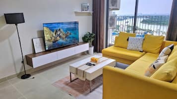 Deluxe Apartment, 2 Bedrooms, Kitchen, City View | Living area | 35-inch TV with cable channels