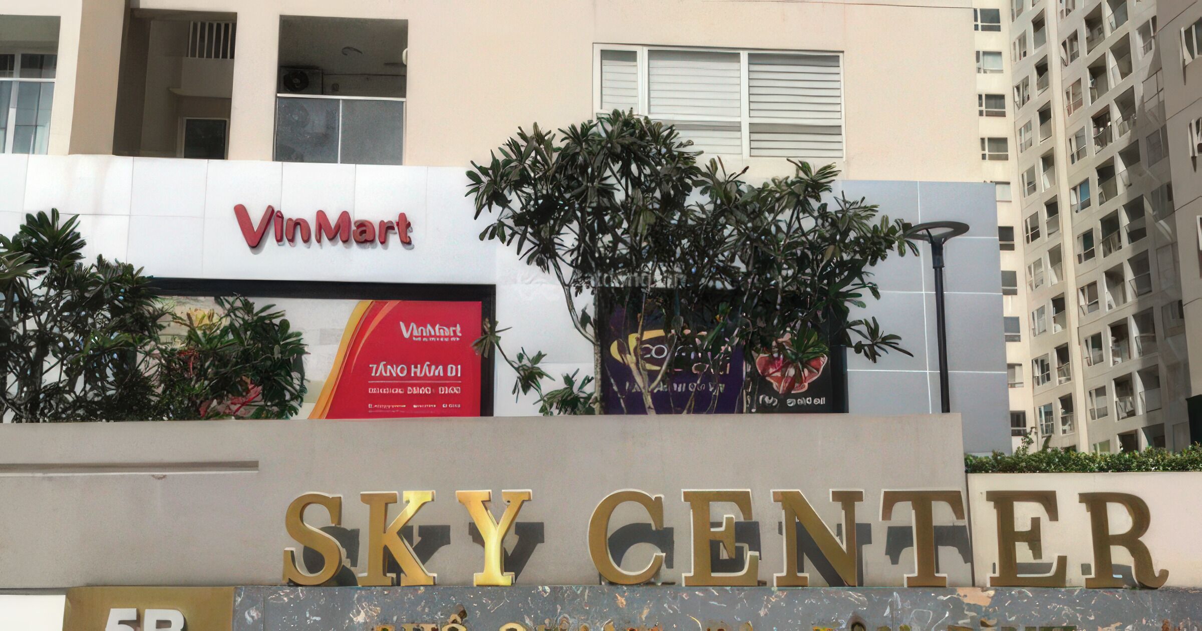 The exterior of a building with a VinMart sign and the words "SKY CENTER" in large letters.