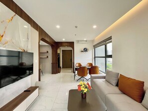 Appartement supérieur, 2 chambres, balcon, vue sur la ville | Aire de séjour | Téléviseur de 35 po avec télévision par câble