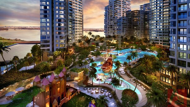 A high-rise hotel with a large swimming pool, palm trees, and a view of the water. - Diamond Island - Mekong Retreat Apartment (Ho Chi Minh City)