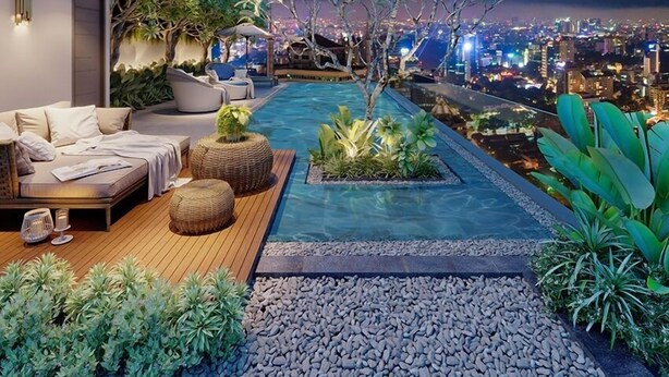 A rooftop terrace with a pool, seating area, and city views at night. - The Serenity Sky Villas D3 (Ho Chi Minh City)