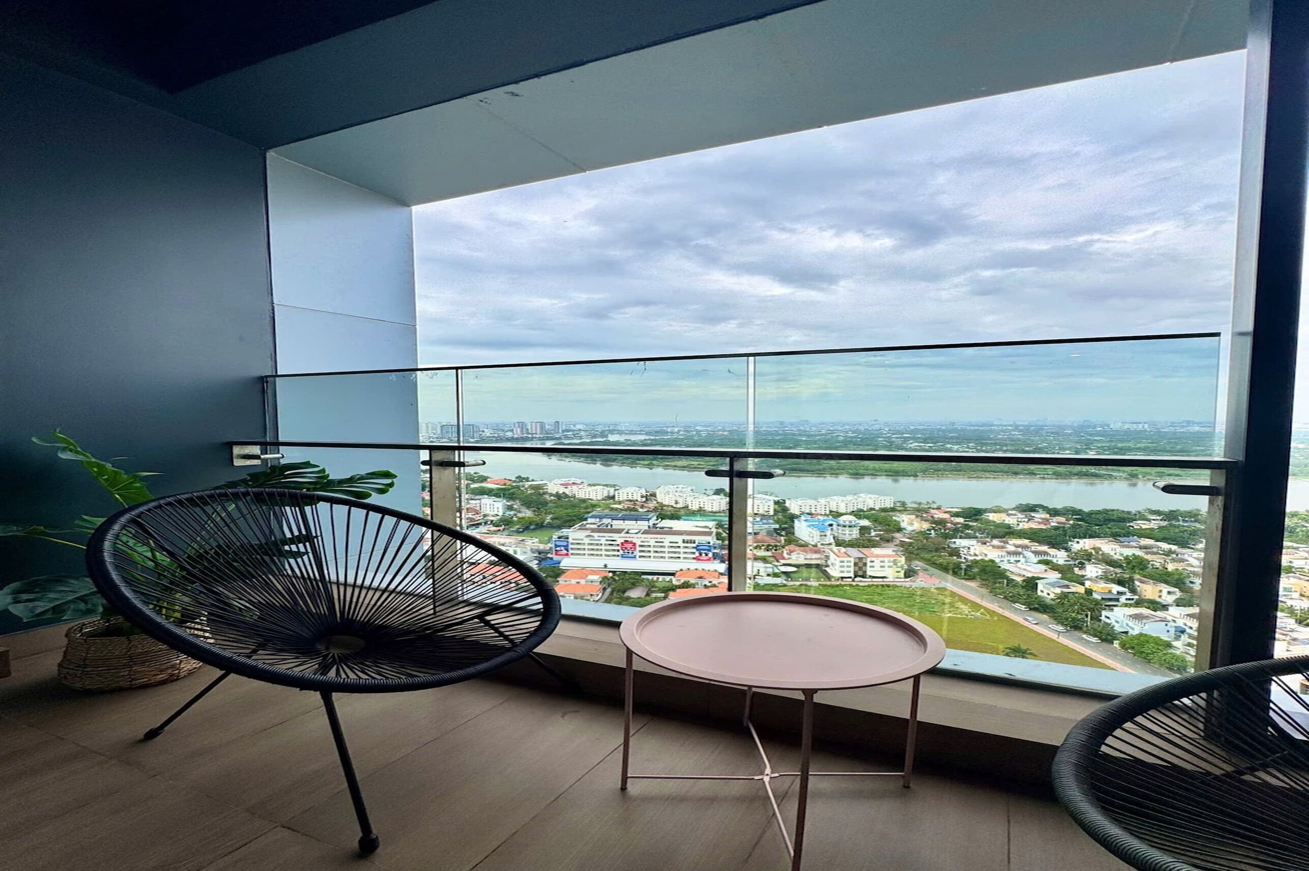 A balcony with a view of a cityscape and river.