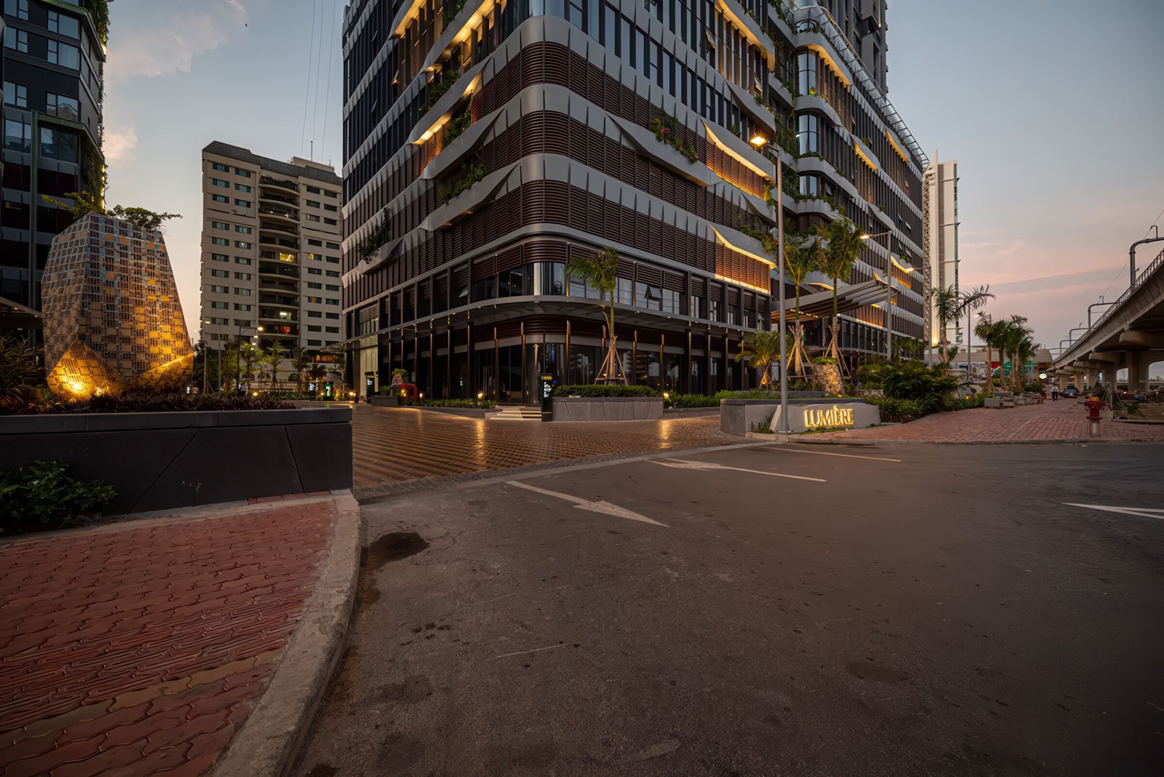 A modern building with multiple floors, large windows, and a well-lit entrance area.