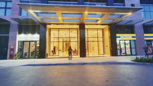 A modern building with a glass entrance, a Ministop convenience store, and a visible office space. - The Sun Avenue - Lalaland & Chill Sky Pool (Ho Chi Minh City)