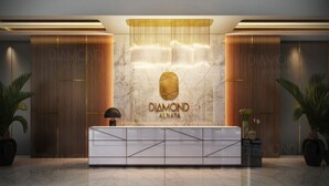 A reception desk with a marble wall, a logo, and two potted plants. - Century Diamond Alnata Plus - Tan Phu (Ho Chi Minh City)