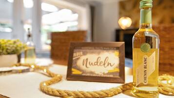 A bottle of Chenin Blanc wine, a framed menu, and a rope on a table.