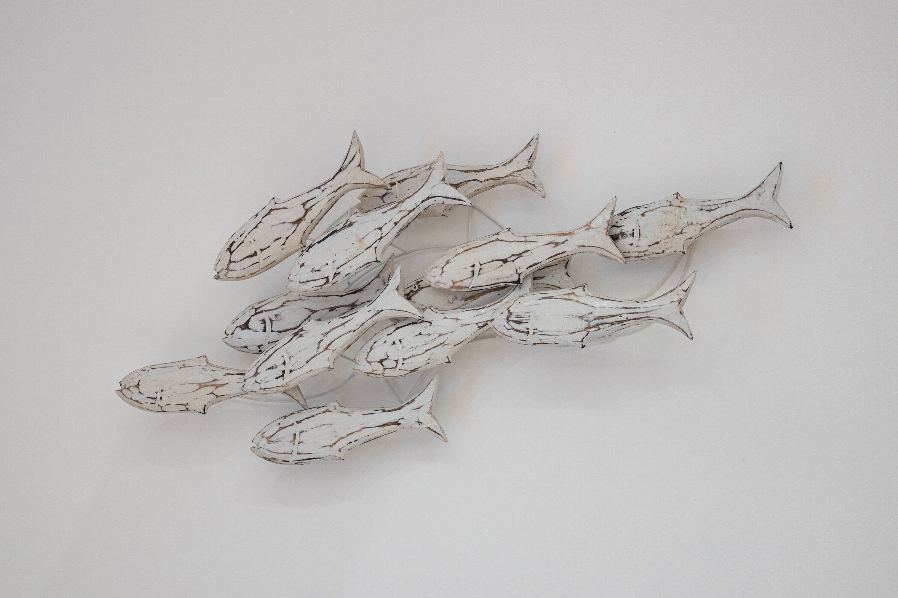 A collection of white, textured fish sculptures.