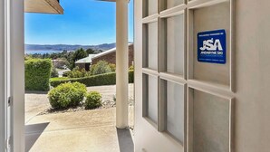 A door with a sign indicating JSA Jindabyee Ski Accommodation. - Dromaius 7 amazing lake and mountain views with double garage (Jindabyne)