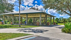 A covered pavilion with benches and a wheelchair-accessible path. - Renovated Rotonda West Oasis w/ Private Pool (Rotonda West)