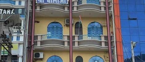 A multi-story building with the sign "Hotel Shree Balaji" prominently displayed.