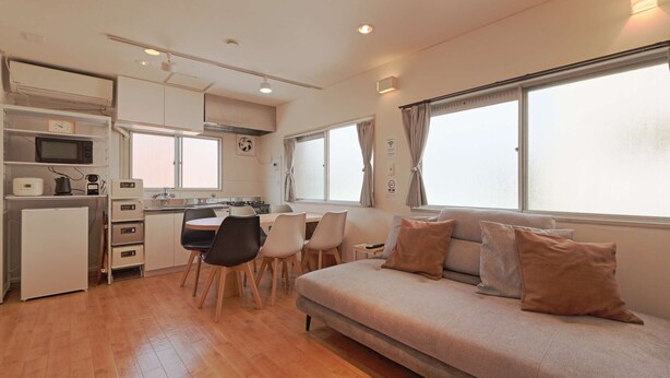 A compact living space with a kitchenette, a dining area, and a sofa. - V.Close to Shinjuku Kabukicho E (Shinjuku-ku)