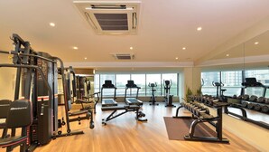 A gym with cardio machines, weightlifting equipment, and dumbbells. - Ginger Hyderabad Airport Road (Hyderabad)