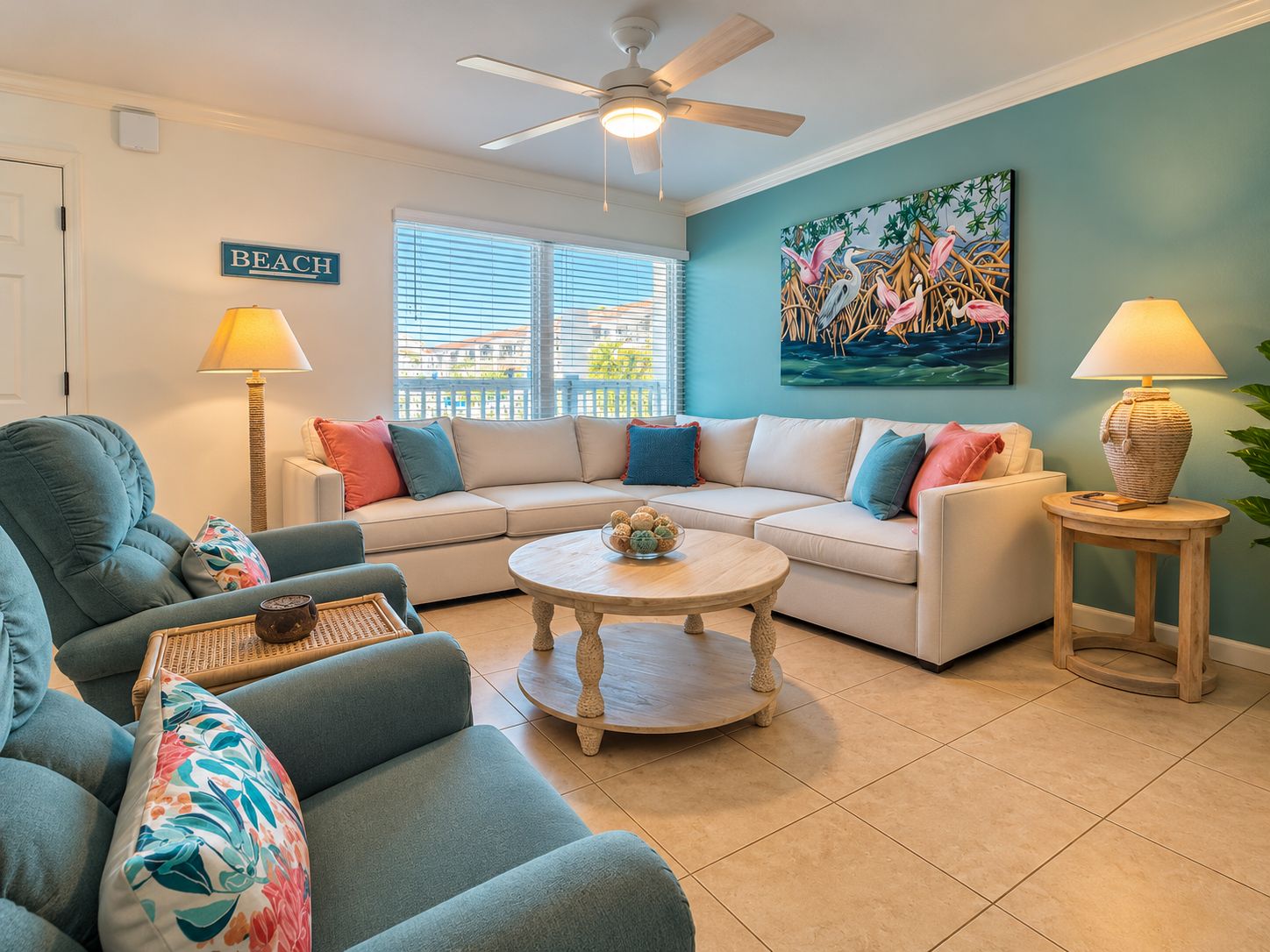 A living room with a sofa, armchairs, a coffee table, and a ceiling fan.