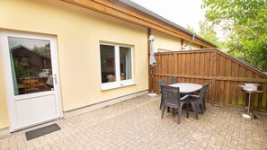 Enjoy al fresco dining on the patio with a barbecue grill and comfortable seating for four.