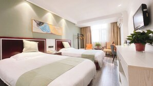 A hotel room with two beds, a desk, a chair, a television, and a painting on the wall. - East Maples Inn Wanda (Wuxi)