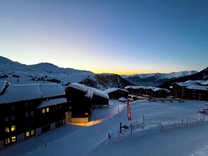 A snow-covered mountain resort with multiple buildings, ski slopes, and a clear sky. - 2 rooms Residence LICORNE App 518 (La Plagne-Tarentaise)